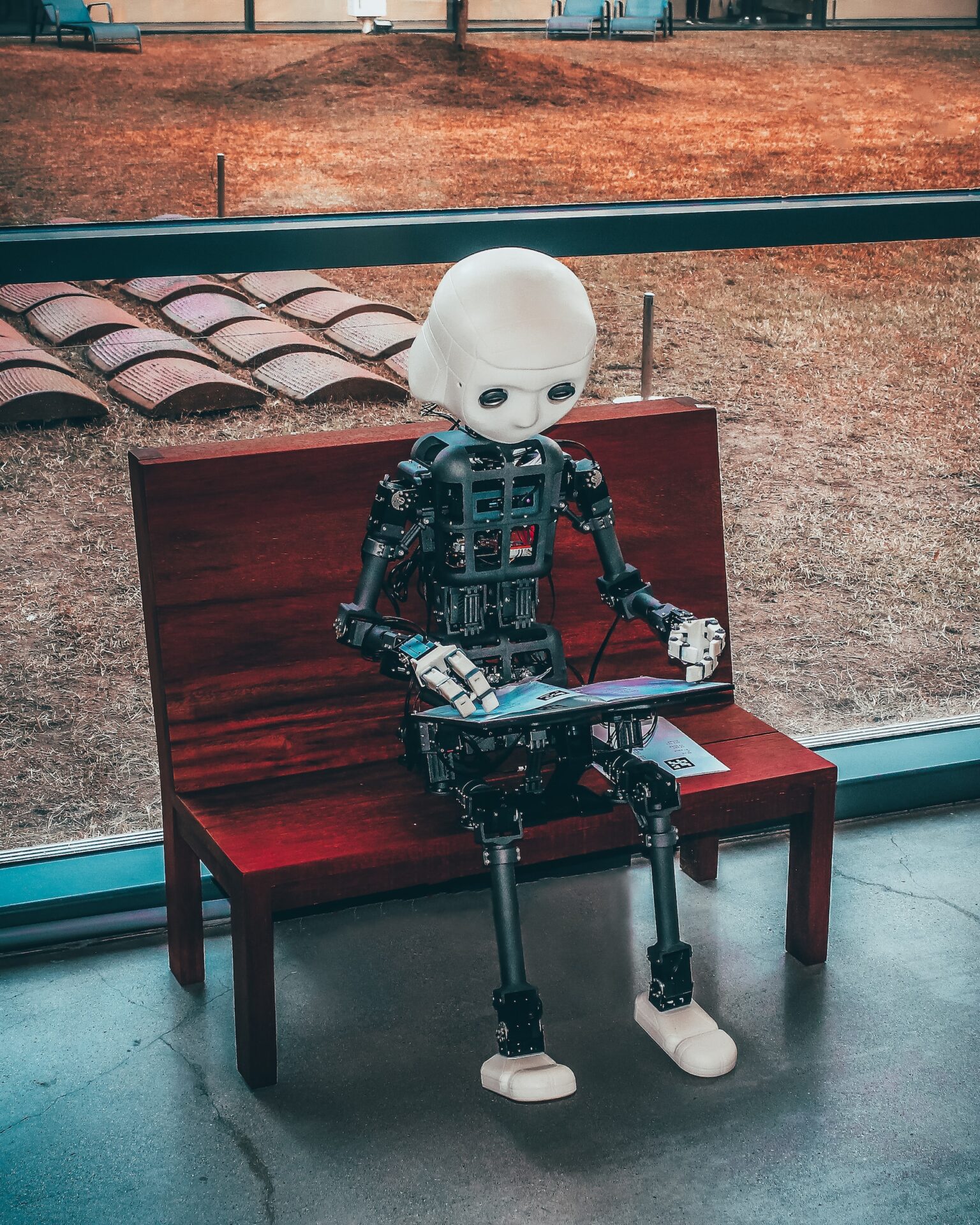 A render of a robot reading a magazine.