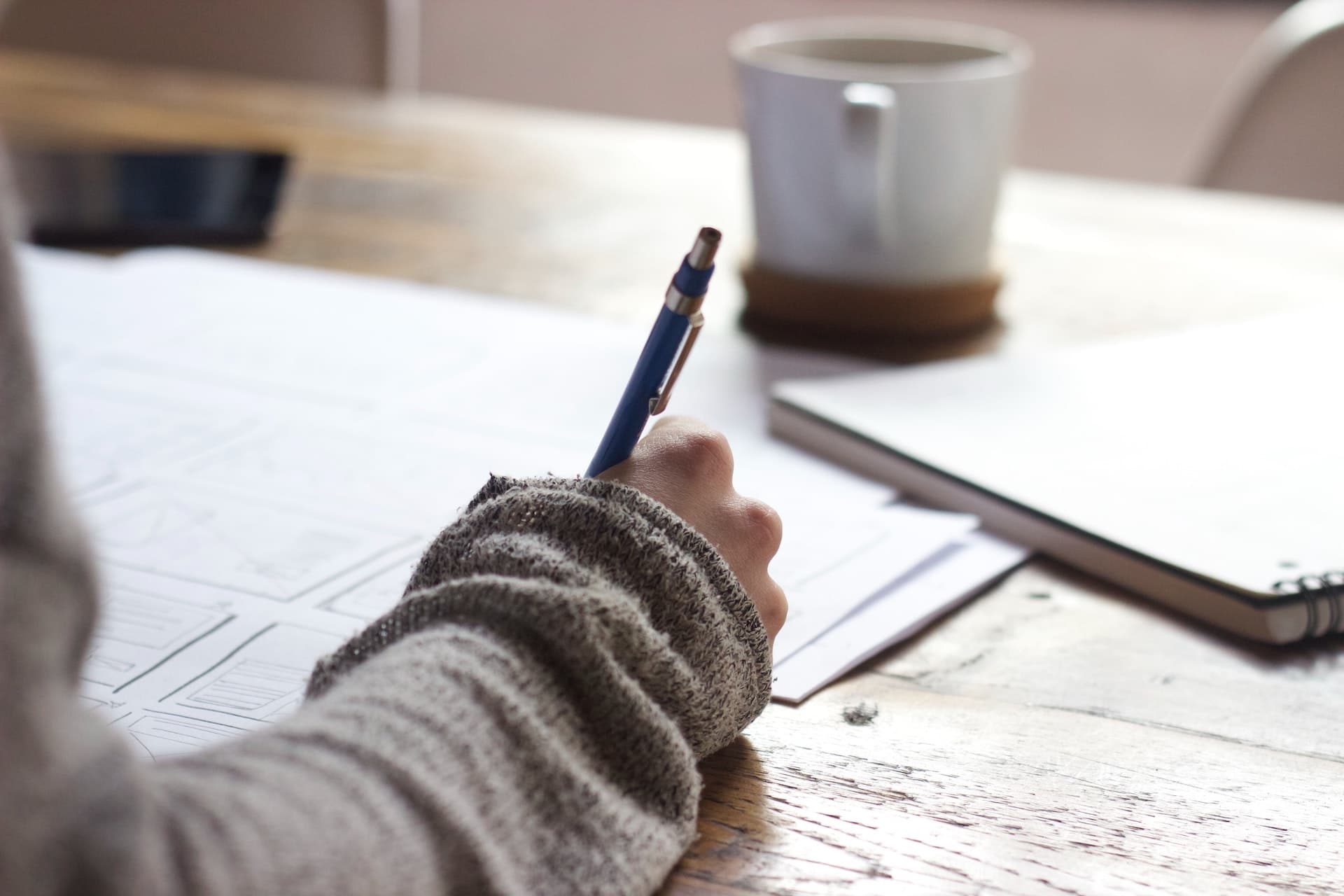 A person writes down information in a notebook.